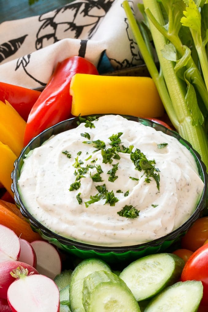 Homemade Ranch Dip Recipe | Homemade Ranch Powder | Homemade Ranch Dressing | Best Ranch Dip #ranch #dip #appetizer #snack #sraye A bowl of dip topped with chopped parsley and surrounded by vegetables.
