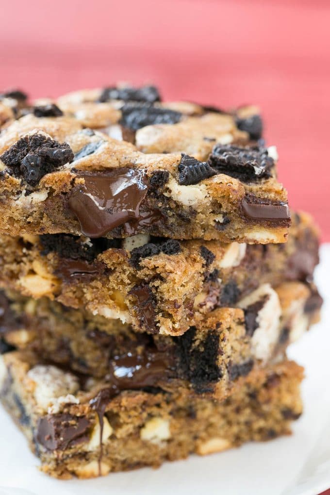 Cookies and Cream Bars Recipe | Oreo Bars | Blondie Recipe #chocolate #oreo #blondies #baking #cookies #sraye A stack of blondies filled with chocolate chunks and chopped cookies.