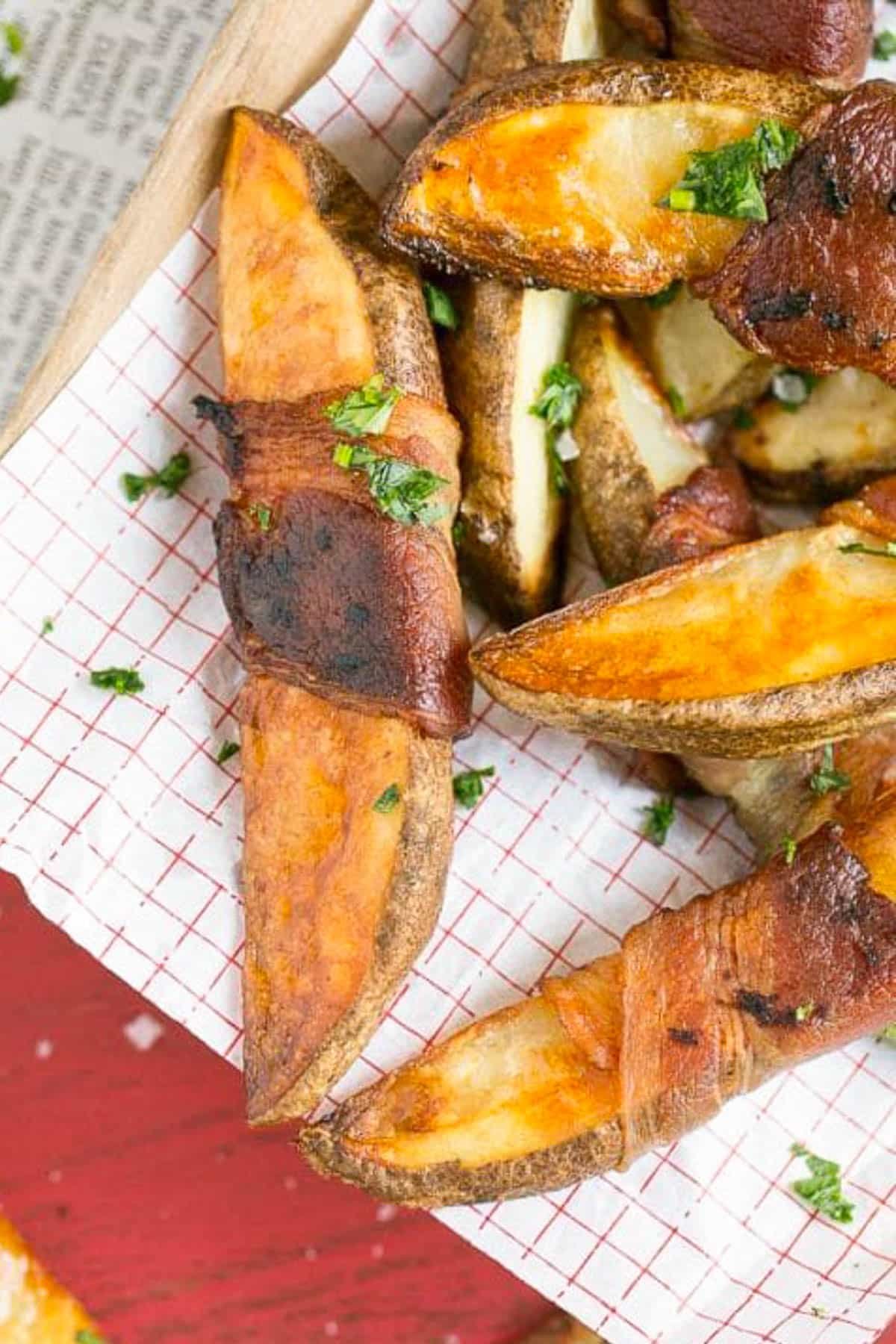 Bacon Wrapped Potato Wedges Recipe | Best Potato Wedges | Bacon Wrapped French Fries | Bacon Potato Wedges #bacon #potato #fries #dinner #sraye Bacon wrapped potatoes on a serving tray, topped with parsley.