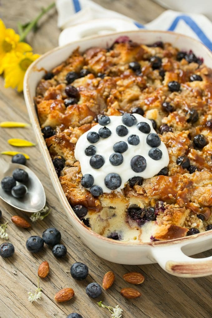 Blueberry Bread Pudding Recipe | Blueberry Bread Pudding | Easy Bread Pudding #blueberry #breadpudding #dessert #sraye A pan of blueberry bread pudding topped with streusel and caramel sauce.