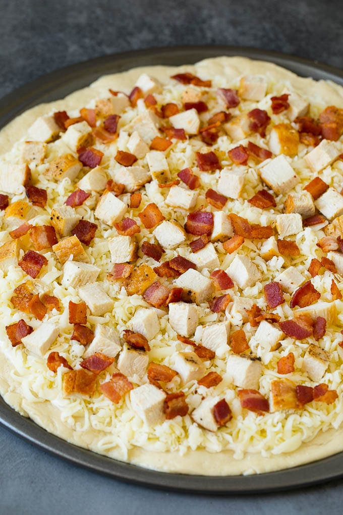 Chicken Alfredo Pizza Recipe #pizza #chicken #bacon #dinner #sraye A crust topped with sauce, shredded cheese and meat.