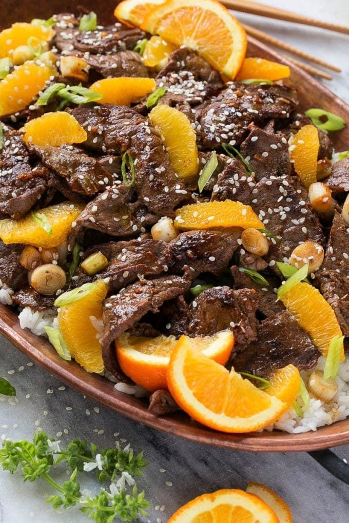 Orange Beef Stir Fry Recipe | 4 Ingredient Orange Beef | Easy Orange Beef #orange #beef #stirfry #asian #dinner #sraye Orange beef topped with green onions and sesame seeds.