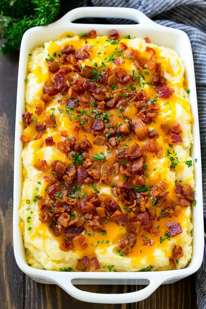 Loaded Mashed Potato Casserole Recipe | Loaded Potatoes | Bacon Mashed Potatoes | Thanksgiving Mashed Potatoes #potatoes #bacon #cheese #casserole #Thanksgiving #dinner #sraye Loaded mashed potato casserole topped with melted cheese, bacon and herbs.