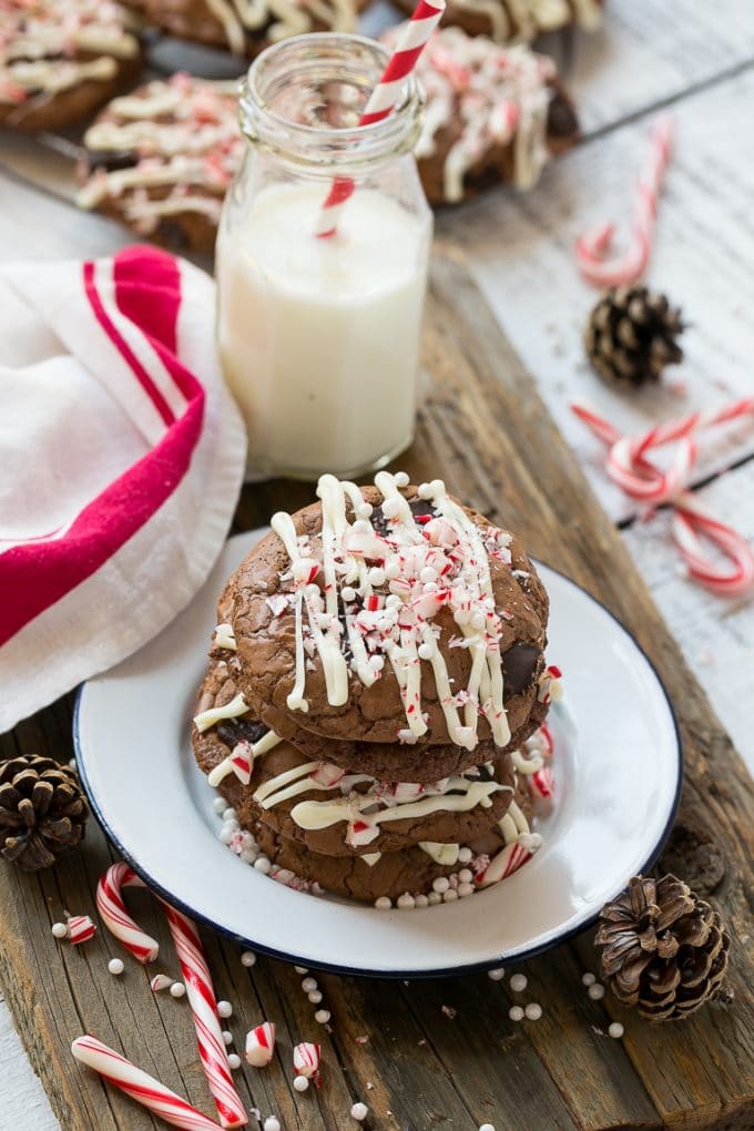 Peppermint Bark Cookie | Easy Peppermint Bark Cookies | Christmas Cookies | Peppermint Bark Cookies | Chocolate Peppermint Cookie #peppermint #peppermintbark #cookies #christmas #holiday #dessert #sraye A plate of chocolate peppermint bark cookies with a bottle of milk on the side.
