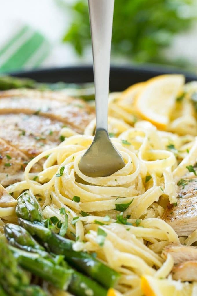 Lemon Asparagus Pasta with Grilled Chicken Recipe | Asparagus Pasta | Grilled Chicken Pasta | Easy Pasta Recipe #pasta #asparagus #lemon #chicken #dinner #sraye A fork serving up a portion of creamy pasta.