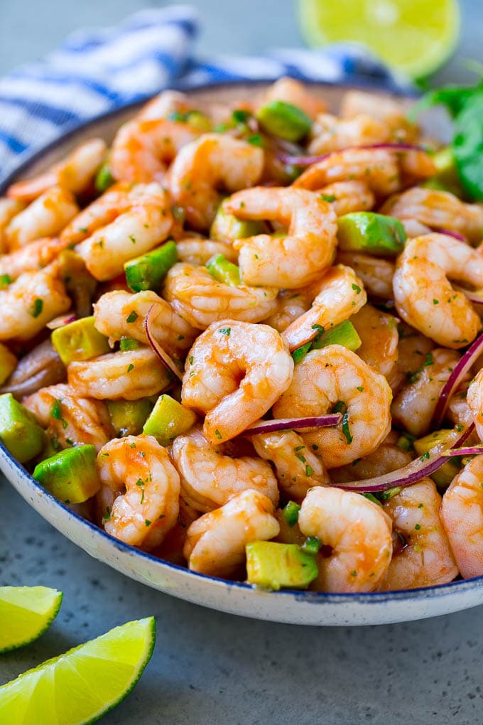 Mexican Shrimp Cocktail Recipe | Coctel de Camarones | Shrimp Cocktail | Mexican Shrimp #shrimp #appetizer #avocado #mexican #sraye A serving bowl of Mexican shrimp cocktail which contains small shrimp, diced avocado, herbs and jalapeno.