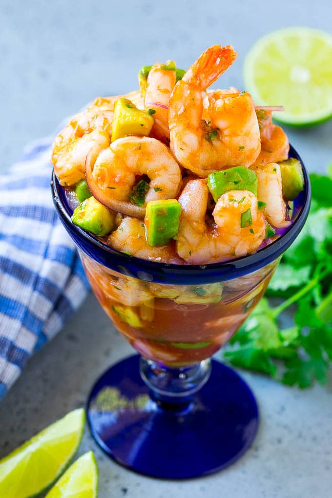 Mexican Shrimp Cocktail Recipe | Coctel de Camarones | Shrimp Cocktail | Mexican Shrimp #shrimp #appetizer #avocado #mexican #sraye An individual cup of Mexican shrimp cocktail with red onion and avocado.