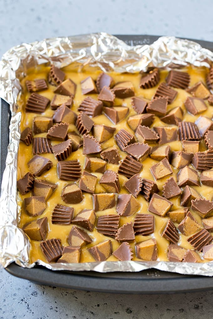 Chocolate Peanut Butter Fudge Recipe | Peanut Butter Cup Fudge | Easy Fudge Recipe #chocolate #peanutbutter #fudge #baking #dessert #sraye Layered peanut butter chocolate fudge in a square pan.