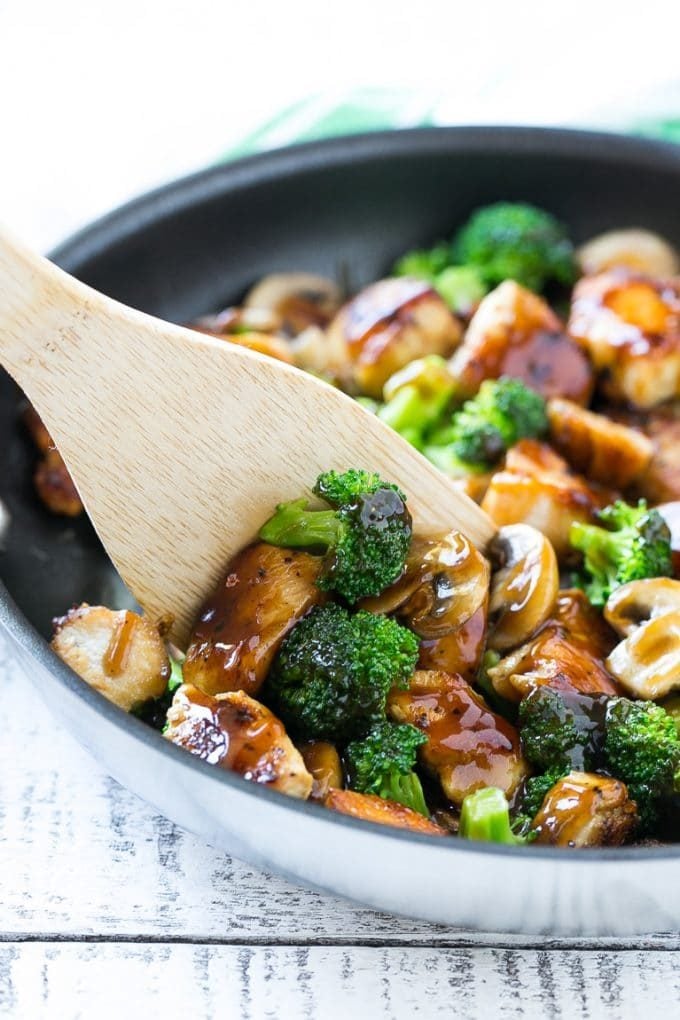Chicken and Broccoli Stir Fry Recipe | Chicken Stir Fry | Healthy Chicken Recipe | Chicken and Broccoli | Chinese Food #chicken #broccoli #stirfry #healthy #cleaneating #dinner #sraye A spatula scooping chicken stir fry out of a pan.