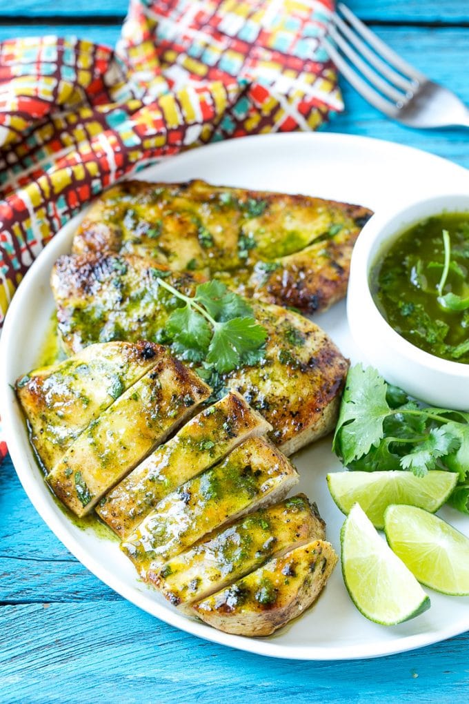 Cilantro Lime Chicken | Grilled Chicken #chicken #grilling #cilantro #lime #dinner #sraye Sliced cilantro lime chicken on a serving plate.