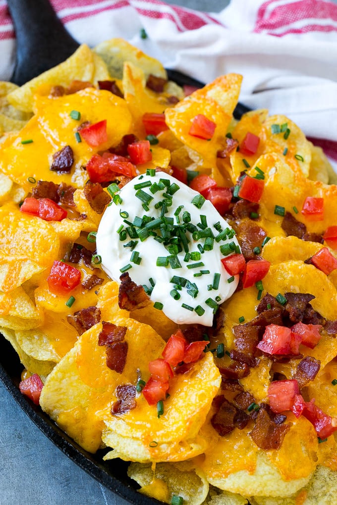 Irish Nachos Recipe | Potato Nachos | Potato Chip Recipe | Appetizer Recipe #nachos #potatoes #cheese #bacon #appetizer #sraye A skillet of Irish nachos topped with melted cheese, bacon, tomatoes and sour cream.