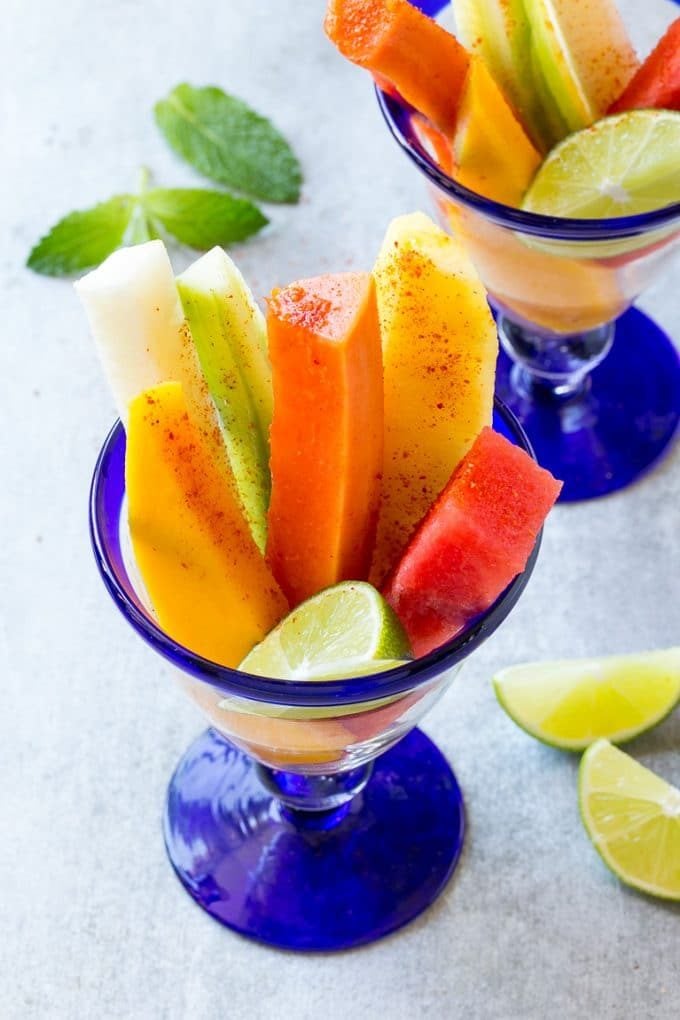 Mexican Fruit Cups | Fruit Cups | Mexican Fruit | Tropical Fruit #fruit #fruitcup #watermelon #pineapple #snack #healthy #sraye Spears of colorful fresh fruit, cucumbers and jicama in Mexican fruit cups.