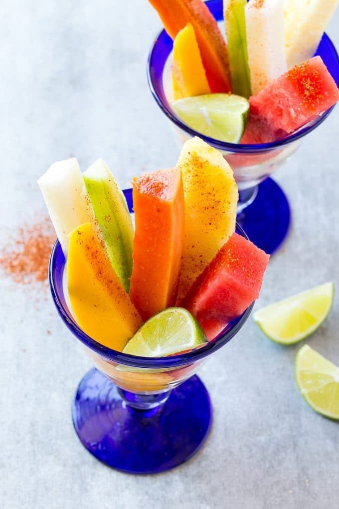 Mexican Fruit Cups | Fruit Cups | Mexican Fruit | Tropical Fruit #fruit #fruitcup #watermelon #pineapple #snack #healthy #sraye Mexican fruit cups with an assortment of fruit, topped with chili lime seasoning.