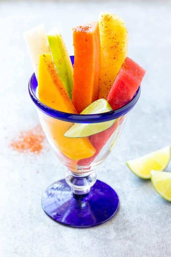 Mexican Fruit Cups | Fruit Cups | Mexican Fruit | Tropical Fruit #fruit #fruitcup #watermelon #pineapple #snack #healthy #sraye Mexican fruit cups topped with chili lime seasoning.