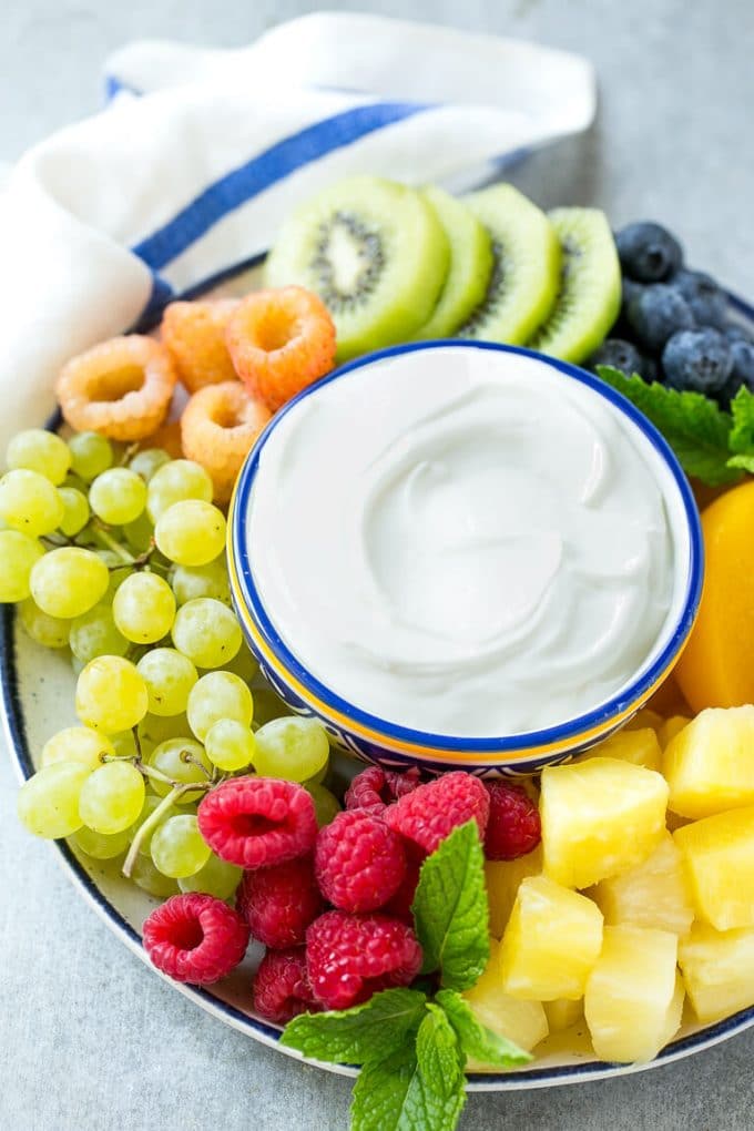 Cream Cheese Fruit Dip | Fruit Recipe | Fruit Dip #fruit #dip #creamcheese #snack #dessert #sraye A bowl of cream cheese fruit dip surrounded by colorful fruit.