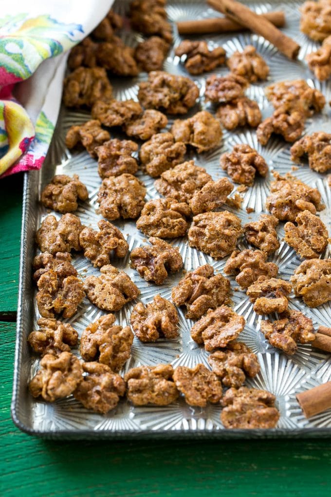 Candied Walnuts Recipe | Candied Nuts | Glazed Walnuts | Cinnamon Sugar Walnuts #walnuts #dessert #snack #sraye A sheet pan with a layer of glazed walnut halves.
