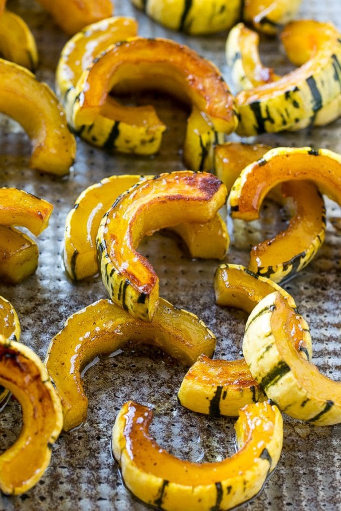 Brown Sugar Delicata Squash Recipe | Roasted Squash | Delicata Squash | Winter Squash Recipe #squash #wintersquash #brownsugar #sidedish #delicatasquash #dinner #sraye Roasted delicata squash on a sheet pan seasoned with brown sugar.