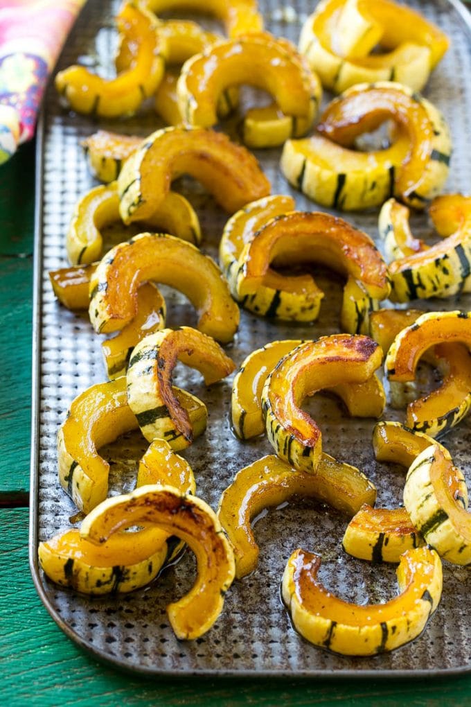 Brown Sugar Delicata Squash Recipe | Roasted Squash | Delicata Squash | Winter Squash Recipe #squash #wintersquash #brownsugar #sidedish #delicatasquash #dinner #sraye A sheet pan of a cooked winter squash recipe.