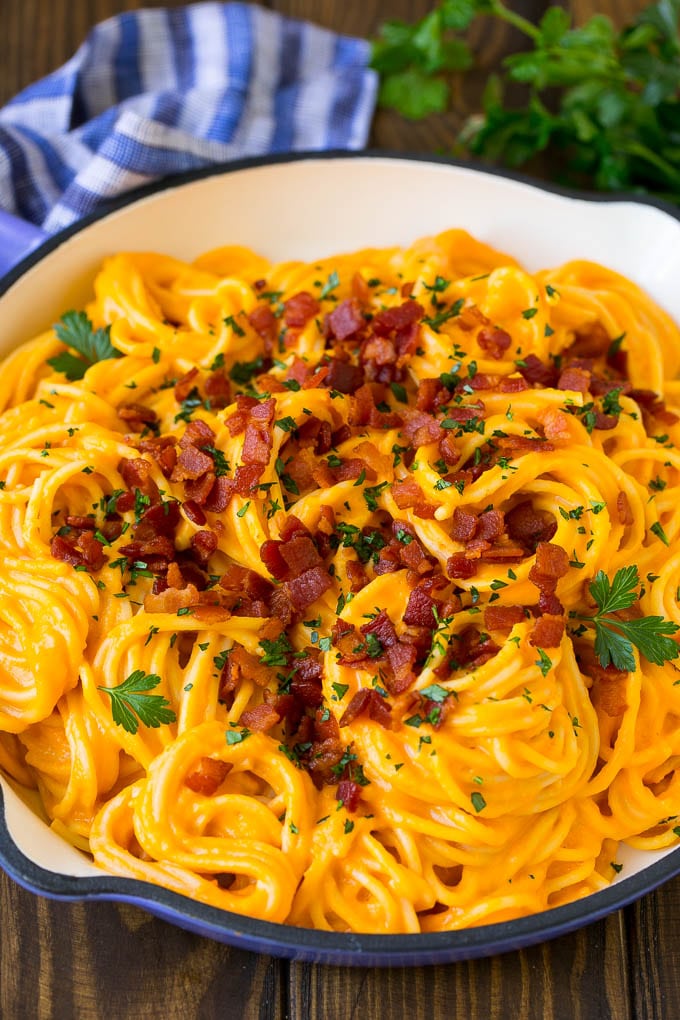 Butternut Squash Pasta Recipe #pasta #squash #bacon #fall #dinner #sraye Butternut squash pasta in a skillet topped with bacon and parsley.