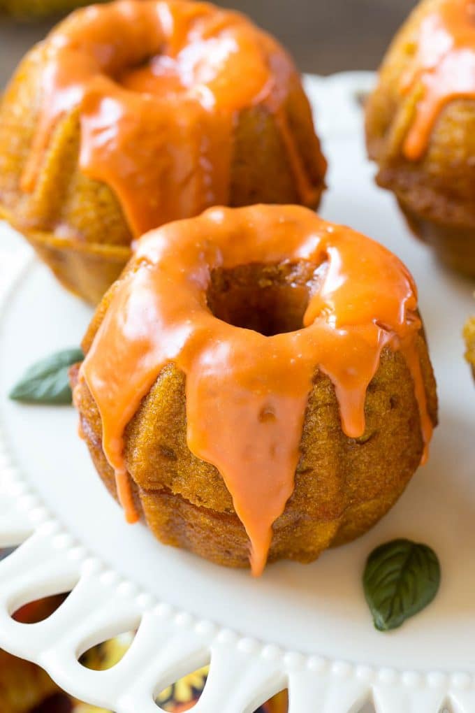 Pumpkin Spice Cake Recipe | Pumpkin Cake | Easy Pumpkin Cake | Thanksgiving Dessert #thanksgiving #pumpkin #cake #pumpkincake #spicecake #dessert #sraye #holiday Two bundt cakes stacked together with orange colored ganache on top.