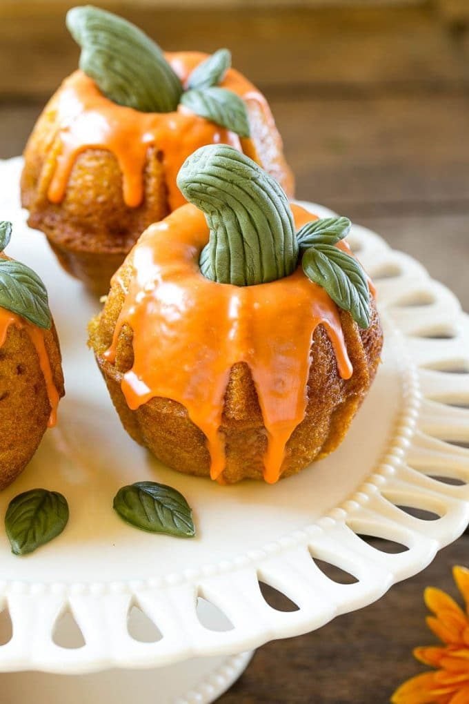 Pumpkin Spice Cake Recipe | Pumpkin Cake | Easy Pumpkin Cake | Thanksgiving Dessert #thanksgiving #pumpkin #cake #pumpkincake #spicecake #dessert #sraye #holiday A platter of pumpkin spice cakes decorated like pumpkins.