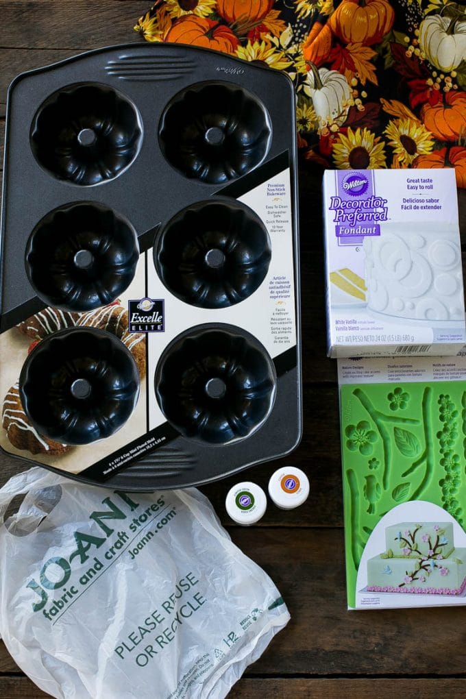 Pumpkin Spice Cake Recipe | Pumpkin Cake | Easy Pumpkin Cake | Thanksgiving Dessert #thanksgiving #pumpkin #cake #pumpkincake #spicecake #dessert #sraye #holiday Cake making tools including fondant, a cake pan, tubs of gel food color and fondant molds.