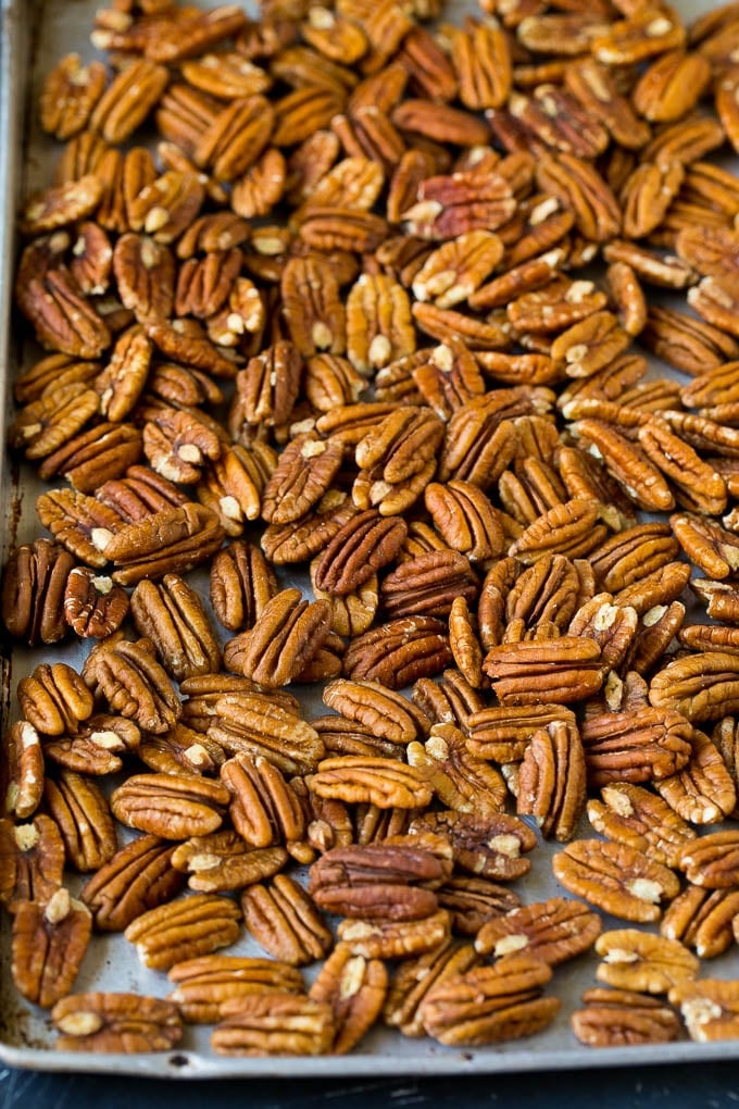 Candied Pecans Recipe | Glazed Pecans | Sugared Pecans #pecans #nuts #snack #dessert #sraye Pecan halves on a sheet pan.