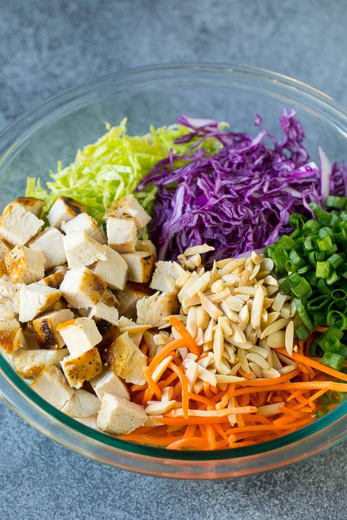 Chinese Chicken Salad Recipe | Asian Chicken Salad #salad #chicken #chickensalad #cabbage #lunch #dinner #sraye Cabbage, carrots, chicken, almonds and green onions in a bowl.