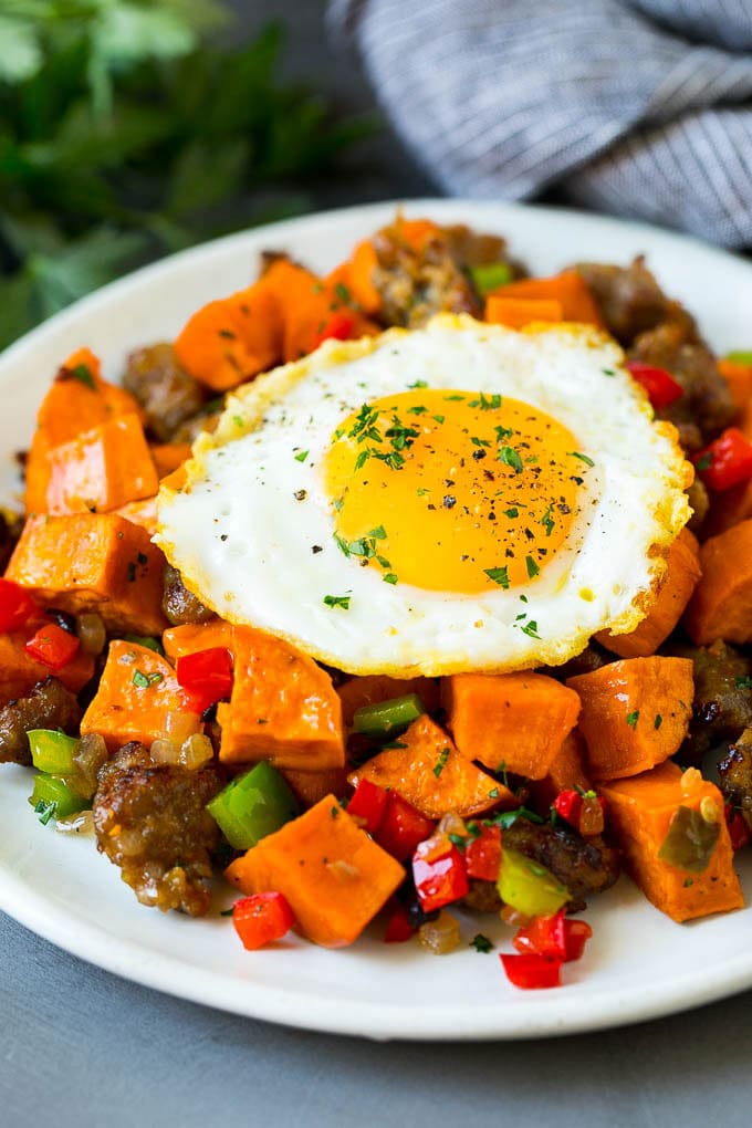 Sweet Potato Hash #sweetpotato #sausage #breakfast #brunch #sraye Sweet potato hash with sausage, topped with a fried egg.