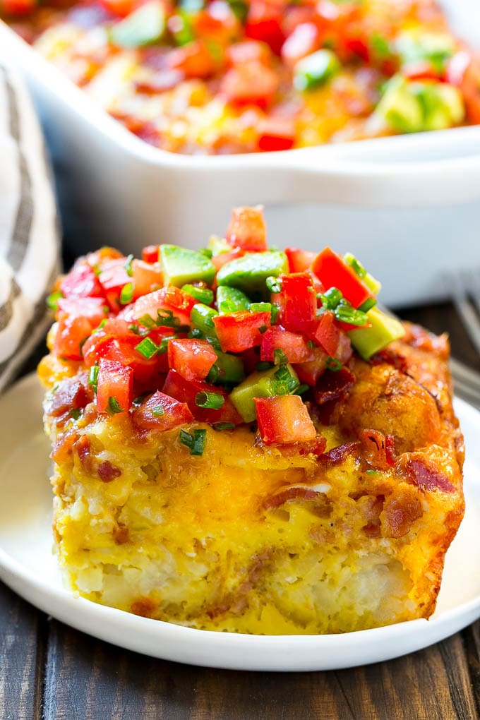 Breakfast Casserole with Bacon Recipe | Bacon and Egg Casserole | Egg Casserole with Bacon | Bacon Breakfast Casserole #eggs #bacon #casserole #breakfast #brunch #sraye A slice of egg casserole with potato tots in it.