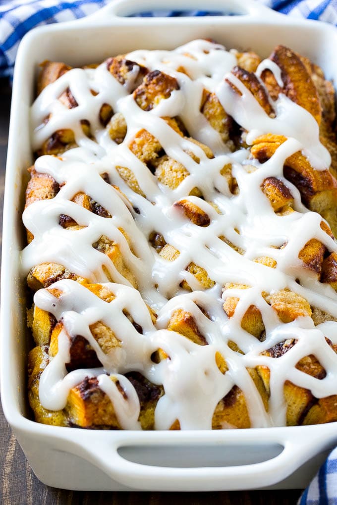 Cinnamon Roll French Toast Casserole | Cinnamon Roll French Toast Bake | Cinnamon Roll French Toast | Cinnamon French Toast #casserole #frenchtoast #cinnamonrolls #breakfast #sraye A cinnamon roll french toast casserole in a baking dish, topped with icing.