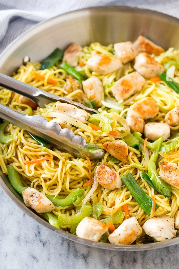 Chicken Chow Mein Recipe | Easy Chicken Recipe | Chow Mein | Chinese Food #chowmein #takeout #asianfood #sraye A pan of chicken chow mein with serving tongs in it.