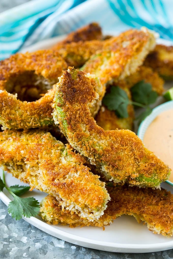 Avocado Fries Recipe | Fried Avocado | Avocado Fritters #avocado #appetizer #snack #sraye A plate of avocado fries garnished with fresh cilantro.