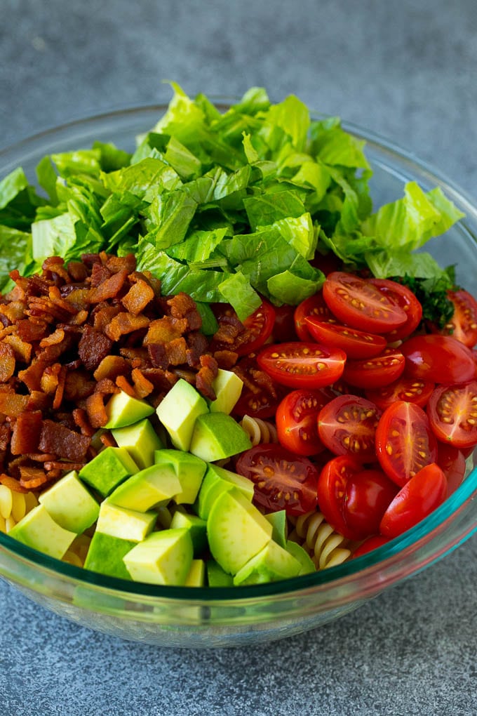 BLT Pasta Salad Recipe | Easy Pasta Salad | Bacon Pasta Salad #salad #pasta #blt #bacon #avocado #dinner #sraye Bacon, lettuce, tomato, pasta and avocado in a bowl.
