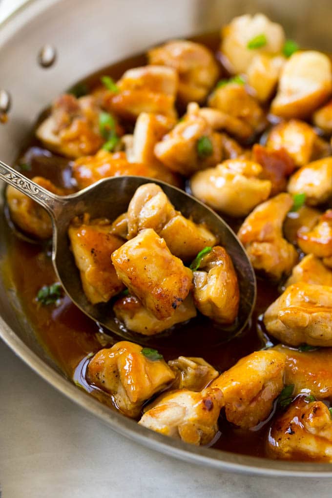 Bourbon Chicken | Sauteed Chicken | Chicken Stir Fry | Easy Chicken Recipe #chicken #dinner #sraye A pan of bourbon chicken with a serving spoon in it.