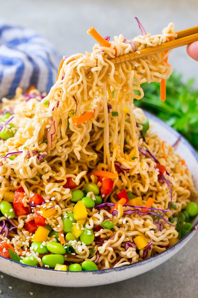 Asian Noodle Salad Recipe | Ramen Noodle Salad | Asian Salad #salad #noodles #edamame #vegetarian #sraye #lunch Chopsticks picking up noodles in a vegetable salad.