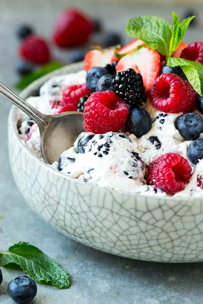 Berry Cheesecake Salad Recipe | Fruit Salad | Berry Fruit Salad | Cheesecake Salad #salad #cheesecake #fruit #berries #sidedish #dessert #sraye Berry cheesecake salad in a bowl garnished with fresh berries and mint.
