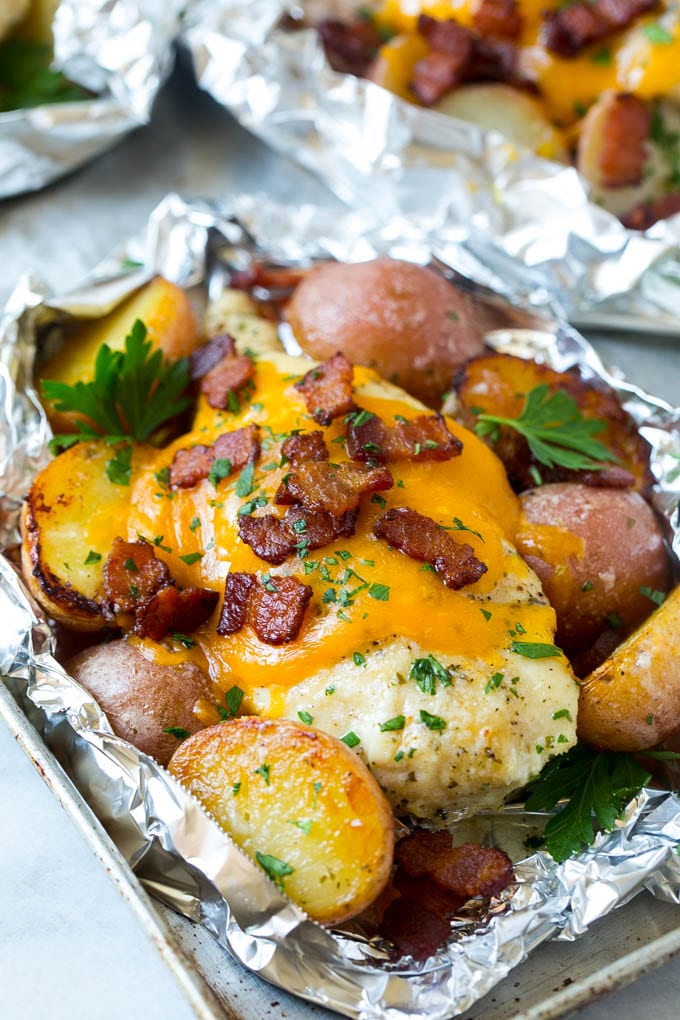 Bacon Ranch Chicken Foil Packets | Chicken in Foil | Foil Packet Recipe | Ranch Chicken #ranchchicken #grilling #chicken #foilpacket #foilpackets #bacon #dinner #sraye Chicken in foil topped with cheddar cheese and bacon.