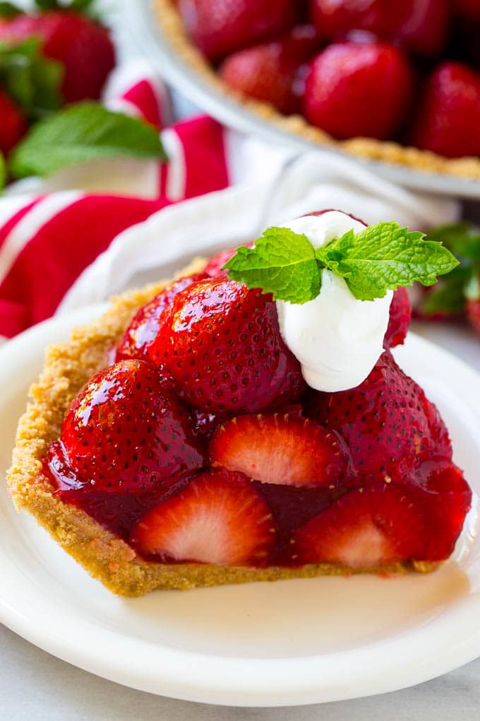 No Bake Strawberry Pie Recipe | Fresh Strawberry Pie | Strawberry Pie Recipe | No Bake Pie Recipe #strawberry #strawberrypie #nobake #nobakepie #dessert #sraye A slice of no bake fresh strawberry pie with whipped cream on top.