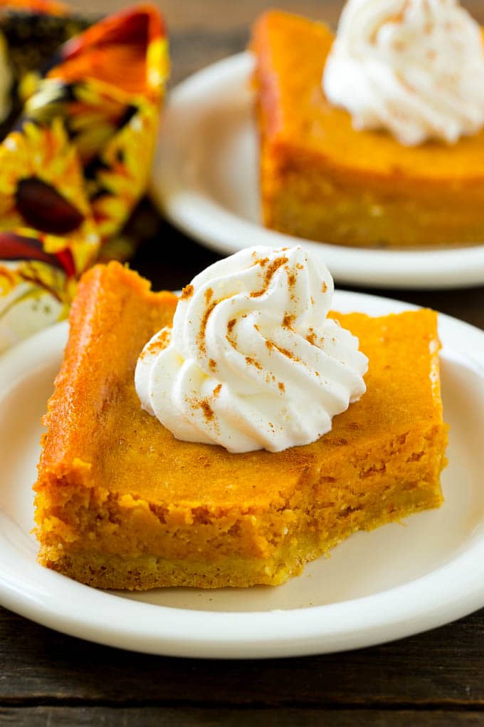 Pumpkin Gooey Butter Cake Recipe | Pumpkin Cake Recipe | Gooey Butter Cake | Pumpkin Dessert | Thanksgiving Dessert #pumpkin #cake #pumpkincake #gooeybuttercake #dessert #sraye A slice of pumpkin butter cake with a bite taken out of it.