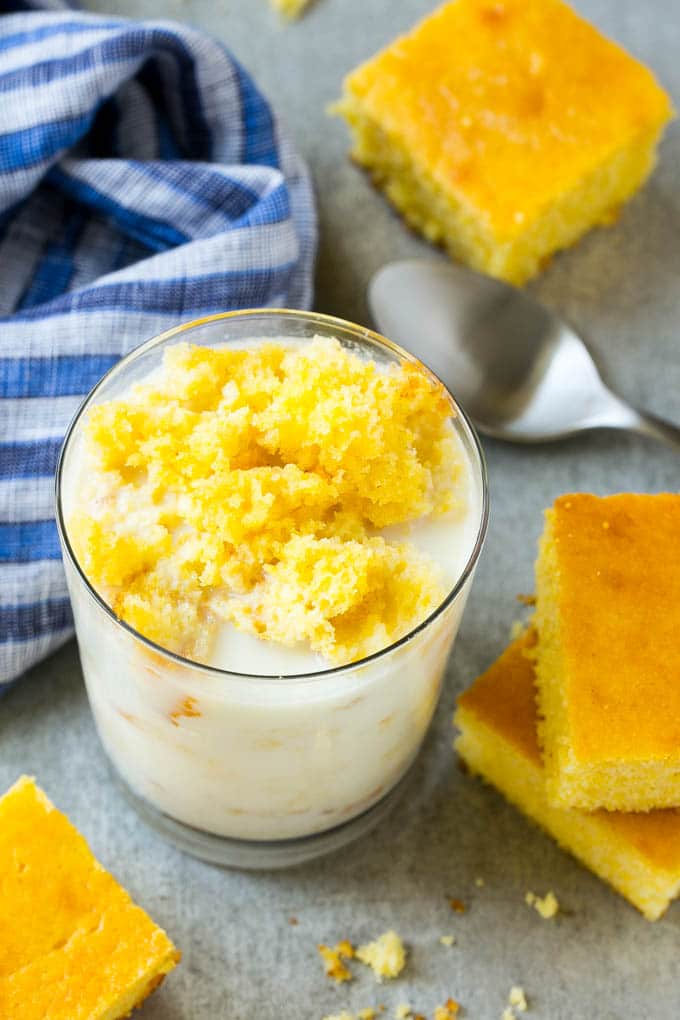 Honey Cornbread Recipe | Buttermilk Cornbread | Easy Cornbread | Homemade Cornbread | Cast Iron Cornbread #cornbread #honey #buttermilk #bread #sraye A glass of milk with cornbread crumbled into it.