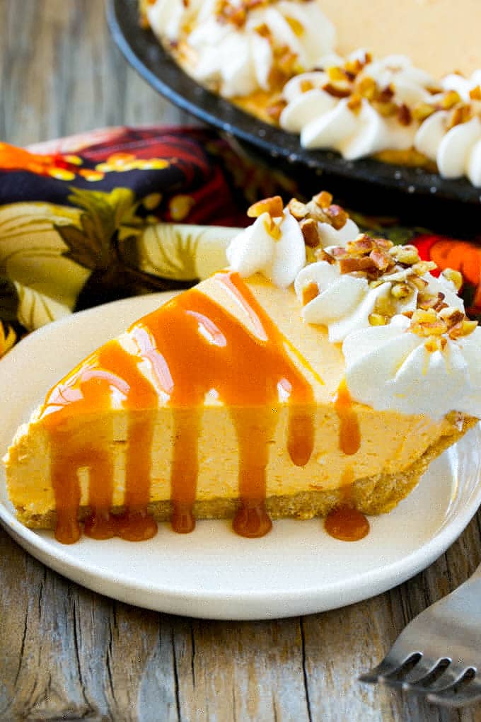No Bake Pumpkin Cheesecake Recipe | Pumpkin Cheesecake | No Bake Cheesecake | Thanksgiving Dessert | Pumpkin Dessert #nobake #cheesecake #pumpkin #pumpkinpie #pumpkincheesecake #nobakecheesecake #dessert #sraye A piece of no bake pumpkin flavored cheesecake topped with caramel.
