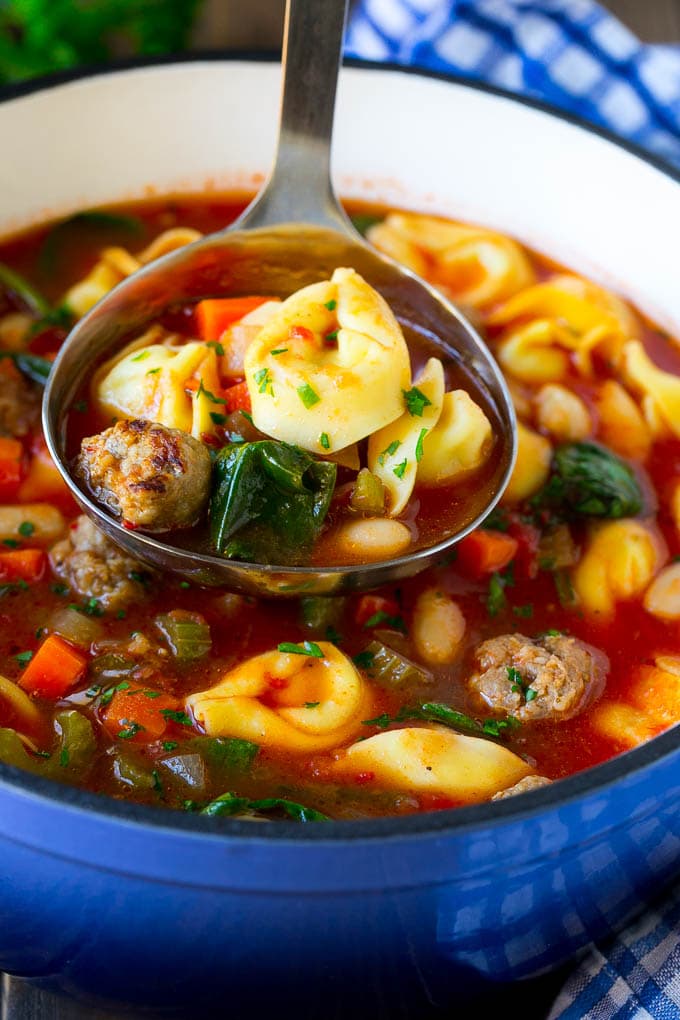 Tortellini Soup Recipe | Sausage Soup | Italian Soup #soup #sausage #pasta #tortellini #dinner #sraye A ladle serving up a portion of tortellini soup.