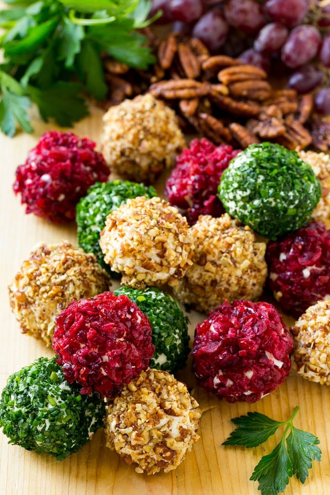 Cheese Ball Bites Recipe | Holiday Cheese Ball Recipe | Pecan Cheese Ball | Cranberry Cheese Ball | Mini Cheese Balls #cheeseball #cheese #appetizer #sraye Cheese ball bites rolled in assorted toppings and served with fruit and nuts.