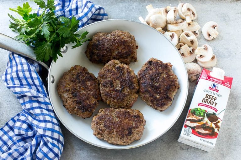 Slow Cooker Salisbury Steak Recipe | Homemade Salisbury Steak | Salisbury Steak from Scratch #steak #beef #salisbury #salisburysteak #slowcooker #crockpot #dinner #sraye Hamburger patties browned in a skillet.