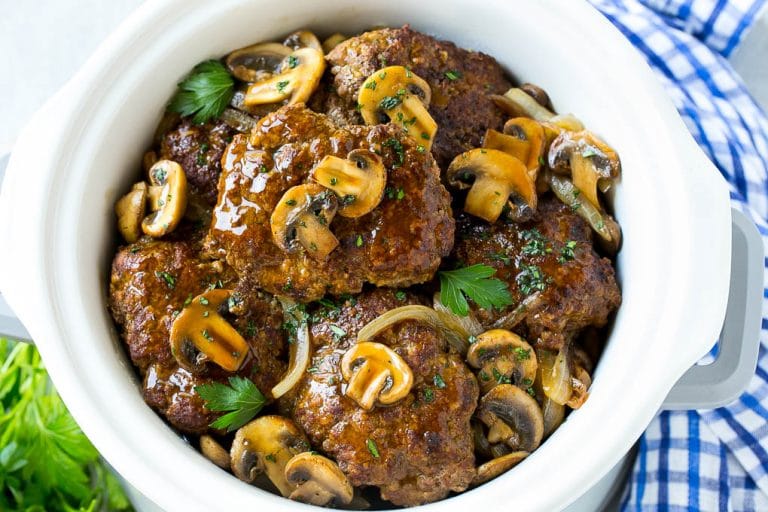 Slow Cooker Salisbury Steak Recipe | Homemade Salisbury Steak | Salisbury Steak from Scratch #steak #beef #salisbury #salisburysteak #slowcooker #crockpot #dinner #sraye A crock pot full of slow cooker salisbury steak.