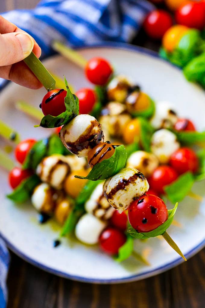Caprese Skewers | Caprese Kabobs | Caprese Appetizer #tomato #mozzarella #basil #caprese #appetizer #sraye A kabob of mozzarella, tomatoes and basil drizzled with balsamic glaze.