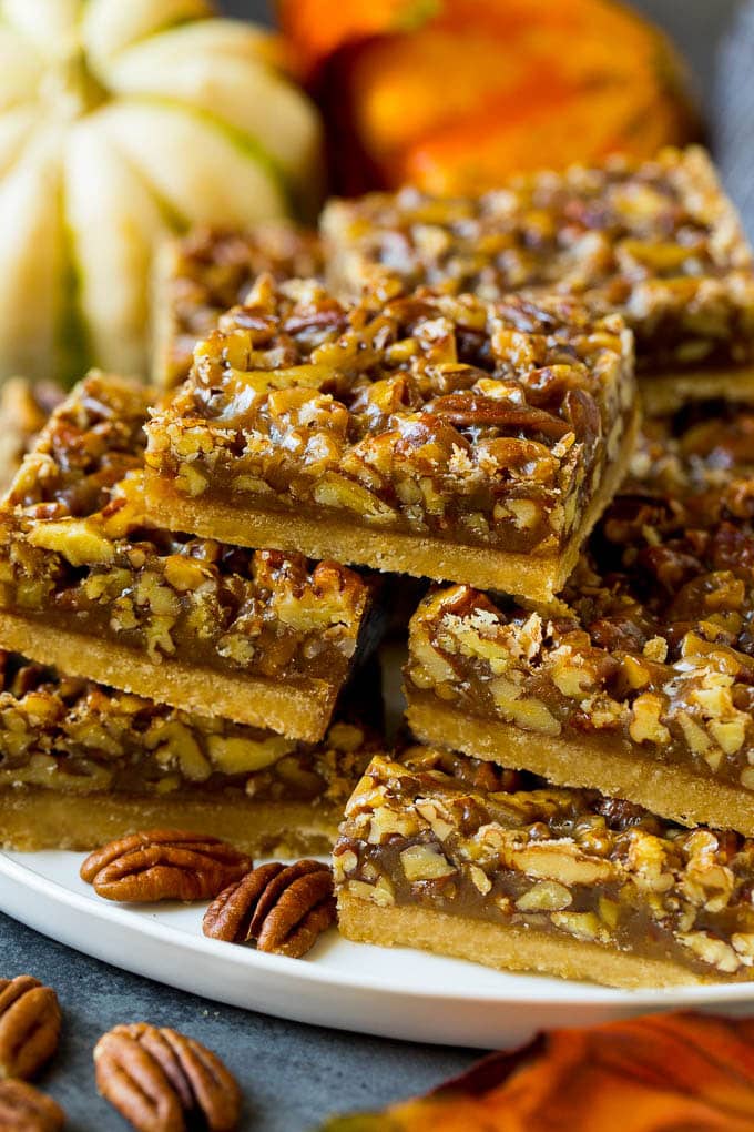 Pecan Pie Bars Recipe #pecans #pie #fall #pecanpie #dessert #thanksgiving #sraye A serving platter full of pecan pie bars.