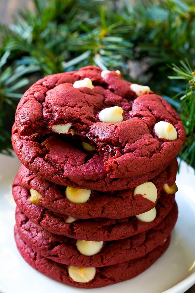 Red Velvet Cookies Recipe | Red Velvet Cookies with White Chocolate Chips | Red Velvet Cake Mix Cookies #redvelvet #cookies #whitechocolate #christmas #sraye A stack of red velvet cookies on a plate.