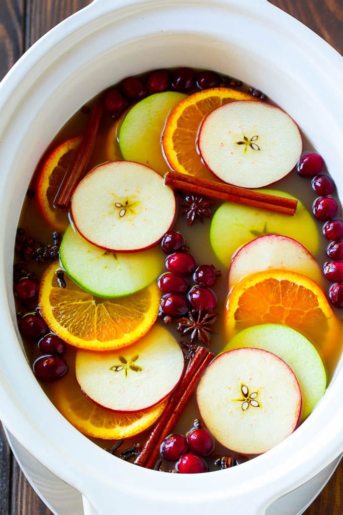 Slow Cooker Apple Cider | Mulled Apple Cider | Crockpot Apple Cider #cider #apple #applecider #drink #crockpot #slowcooker #sraye Slow cooker apple cider garnished with apple slices, oranges, cranberries, cinnamon sticks and spices.